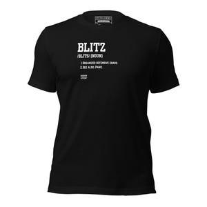 May include: A black short-sleeved t-shirt featuring white text on the chest that defines the word BLITZ as organized defensive chaos and see also panic, with the brand name Gridiron Lexicon printed below the definition and an Uncaged logo at the neck.