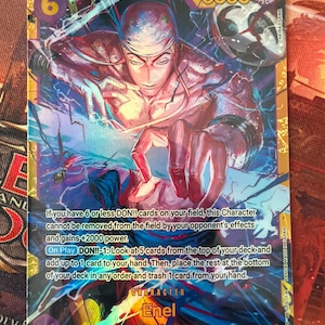May include: A collectible trading card featuring Enel from Sky Island. The card has a vibrant illustration of a character with a determined expression, surrounded by blue and purple energy effects. The card displays the number 6, the power level 8000, and text describing the character's abilities.