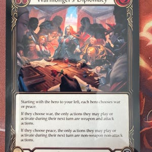 May include: A trading card titled "Warmonger's Diplomacy" with a detailed illustration of a group of figures around a table. The card has text describing game actions and is labeled as a "Generic Action" with a value of 3.