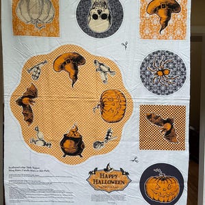 May include: A white Halloween-themed fabric panel with orange and black illustrations. The design includes pumpkins, bats, witch hats, a skull, and the text "Happy Halloween". Intended for table toppers, mug mats, or hot pads.