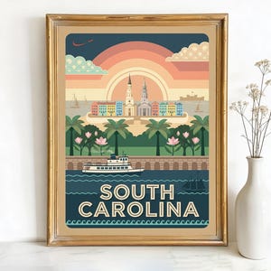 May include: A framed art print featuring a vintage-style illustration of South Carolina. The artwork showcases a sunset, buildings, palm trees, a boat, and the text "SOUTH CAROLINA" in a retro font. The frame is gold.