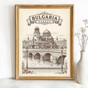 May include: Framed print of Bulgaria, Europe, featuring a detailed black and white illustration of a cathedral and bridge. The print is in a gold frame and includes the word "Bulgaria" in a banner.