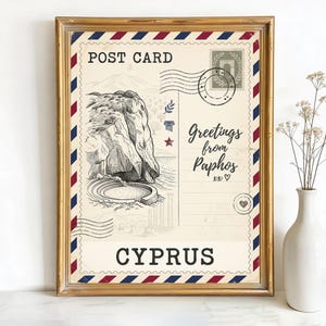 May include: Framed postcard print featuring a vintage illustration of Cyprus. The design includes the words "POST CARD", "Greetings from Paphos", and "CYPRUS". The frame is gold with red, white, and blue accents.