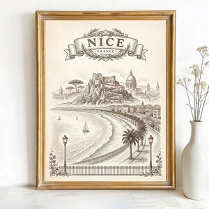 May include: Framed vintage-style print of Nice, France, featuring a detailed black and white illustration of the city's coastline, buildings, and a banner that reads "Nice France". The print is in a gold frame.