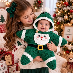 May include: A star-shaped crochet baby bunting in dark green with white trim, featuring a Santa Claus face applique, a black belt with a yellow buckle, and a hood topped with a white pom-pom. The garment has long sleeves and a button closure.