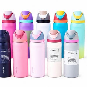 May include: A collection of ten Owala insulated water bottles in various colors including pink, purple, white, blue, and gray. Each bottle features a flip-top lid with a built-in straw and a label stating, Hi there, proof. I'm insulated. I have a built-in straw.