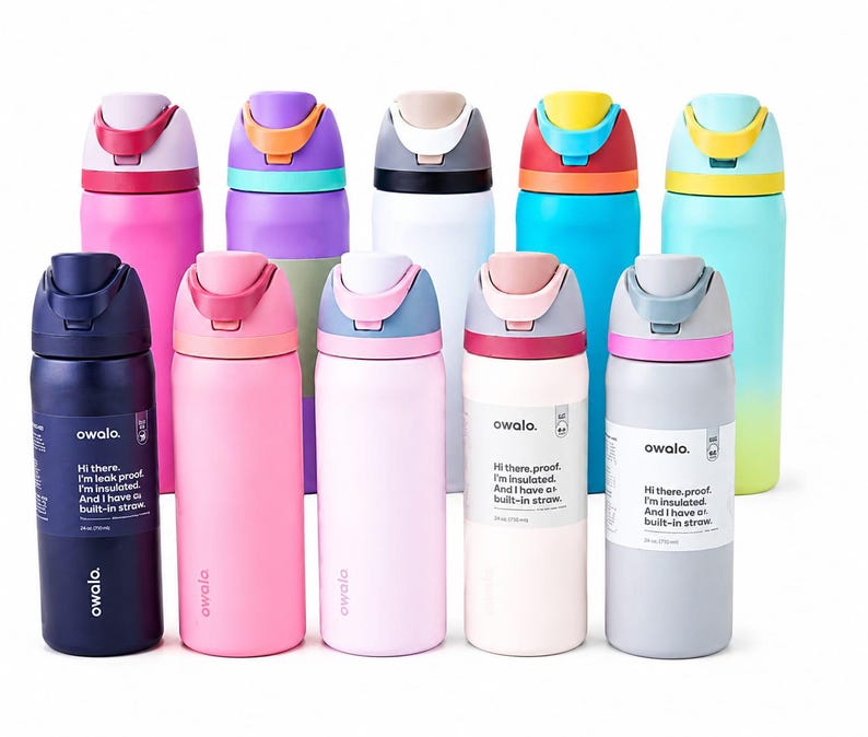 May include: A collection of ten Owala insulated water bottles in various colors including pink, purple, white, blue, and gray. Each bottle features a flip-top lid with a built-in straw and a label stating, Hi there, proof. I'm insulated. I have a built-in straw.
