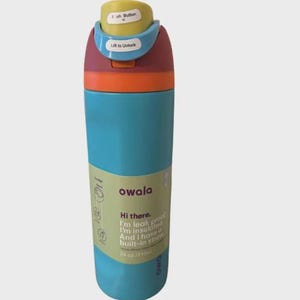 May include: A multi-colored Owala water bottle with a teal body, orange ring, and a maroon lid featuring a yellow push button and light blue lock. The label reads: Hi there. I'm leak proof. I'm insulated. And I have a built-in straw. 24 oz / 710ml.