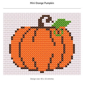 May include: A cross-stitch pattern of a Mini Orange Pumpkin on white fabric. The pumpkin is orange with dark brown outlines and a green leaf. The text Mini Orange Pumpkin and Design size: 40 x 32 stitches are visible on the white background.