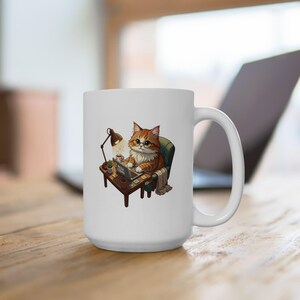 Pode incluir: Caneca de cerâmica branca com um gato de desenho animado usando óculos e trabalhando em um laptop. O gato está sentado em uma pequena mesa com uma lâmpada e uma xícara de café. A caneca tem uma alça grande.