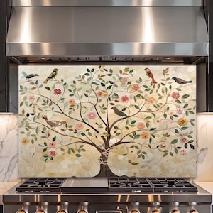 May include: A rectangular kitchen backsplash panel featuring a mosaic-style illustration of a tree with a dark brown trunk and branches. The tree is adorned with green leaves, various colorful flowers, and several birds perched on the branches.