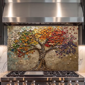 May include: A rectangular wall art panel featuring a textured, three-dimensional tree with a thick, metallic-toned trunk and branches. The foliage is composed of numerous small, raised petal shapes in a vibrant gradient of colours including green, yellow, orange, red, and purple, set against a neutral, brush-stroked background.