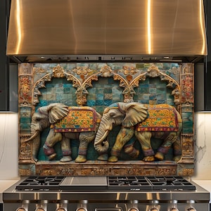 May include: A decorative kitchen backsplash panel featuring a relief sculpture of two elephants adorned with colorful blankets. The elephants are set against a background of teal square tiles framed by ornate, carved architectural arches.