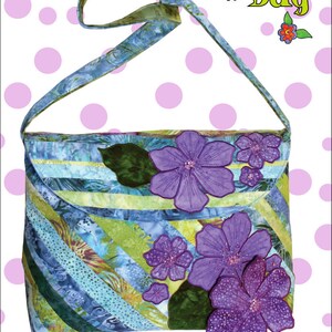 May include: A sewing pattern for a purple and blue floral handbag called "Annabella Bag". The pattern is from Cool Cat Creations and is for a bag made from Bali Pop and Blue Hawaiian fabric. The pattern is number CCC 114.