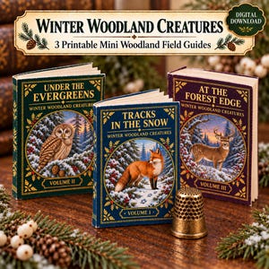 May include: Three miniature books titled Winter Woodland Creatures, featuring illustrations of an owl, a fox, and a deer in snowy settings. The covers are dark green, blue, and purple with gold text. A brass thimble sits in front of the books.
