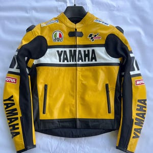 May include: Yellow and black Yamaha motorcycle racing jacket with white detailing. Features the Yamaha logo, AGV logo, and Motul branding. Includes a zip closure and black shoulder pads.