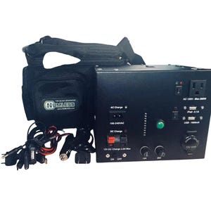 May include: A black portable power station with a Humless logo on the attached carrying bag. The unit features an AC 120V outlet, USB ports, a 12V power outlet, and various charging cables. The front panel includes labels for AC and DC charging.