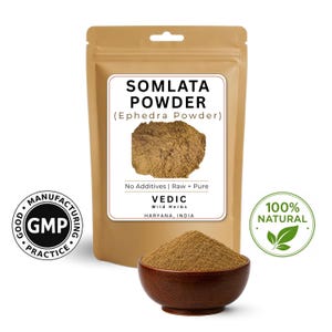 May include: A brown pouch of Somlata Powder (Ephedra Powder) with a white label. The label includes the text "No Additives | Raw + Pure" and "VEDIC Wild Herbs HARYANA, INDIA". A small wooden bowl contains the powder. A "100% NATURAL" sticker is visible.