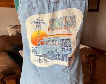 Mouwloos denim overhemd met knopen en een tweedehands Orange Beach-t-shirt om een geüpcycleerde schat te creëren.