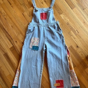 Patchwork overalls upcycled with frayed fabric inserts to create a unique item.
