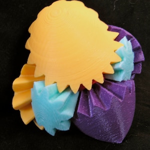 May include: A 3D printed sculpture made of interlocking gears in various colors, including yellow, purple, and blue.