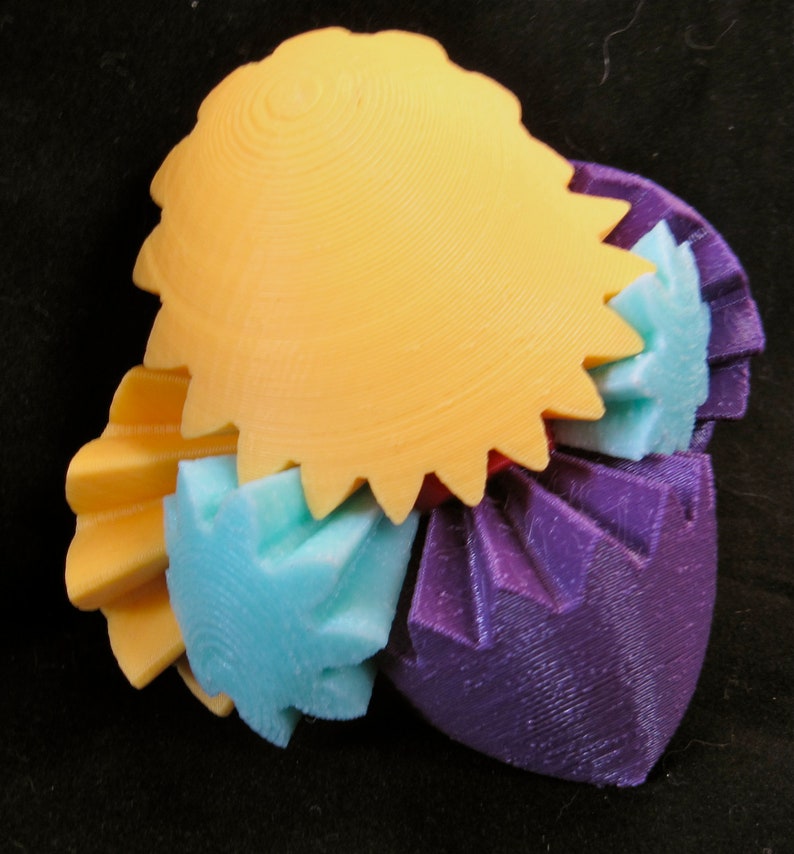 May include: A 3D printed sculpture made of interlocking gears in various colors, including yellow, purple, and blue.