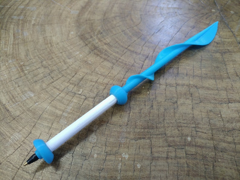 May include: A blue plastic pen with a white barrel and a spiral design. The pen is lying on a wooden surface.