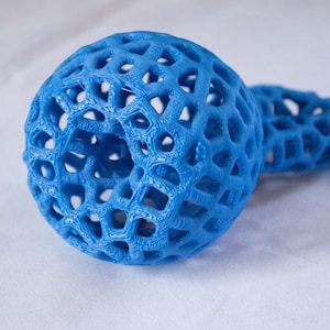 May include: A blue 3D printed object with a lattice design. The object is shaped like a sphere with a smaller sphere attached to it.