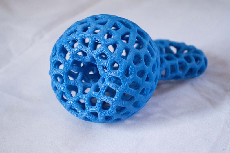 May include: A blue 3D printed object with a lattice design. The object is shaped like a sphere with a smaller sphere attached to it.
