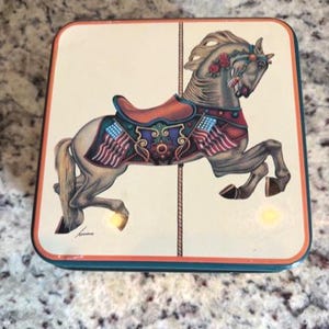 Vintage Vandor Tin Featuring A Whimsical Carousel Horse