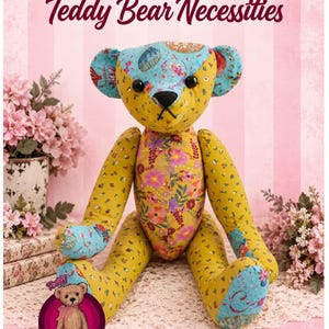 May include: A stuffed teddy bear made from various floral and patterned fabric patches in shades of yellow, blue, and pink. The bear features black button eyes and a stitched nose. Text at the top reads 18" PATCHES Teddy Bear Necessities.