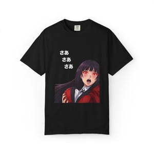 May include: Black t-shirt featuring an anime character with red eyes and a surprised expression. The character is wearing a red jacket and white shirt. Japanese text is printed above the character's head.