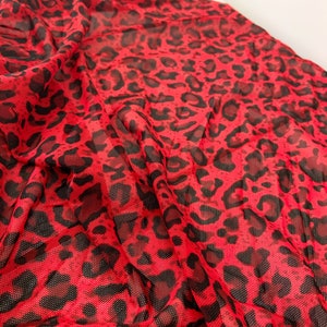 May include: Red mesh fabric with a black leopard print pattern.