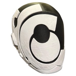 May include: A full-face mask featuring a black mesh front panel overlaid with a large, white, stylized letter C. The mask has a smooth, rounded black outer shell with white geometric accents along the sides and a white chin guard section.