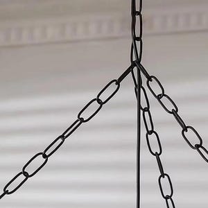 May include: A black metal chain assembly consisting of three individual chains that converge at a single top point. The links are oval-shaped and uniform in size, creating a sturdy suspension system for a hanging fixture or decorative object.
