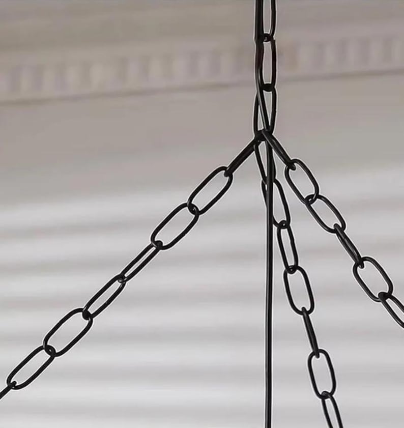 May include: A black metal chain assembly consisting of three individual chains that converge at a single top point. The links are oval-shaped and uniform in size, creating a sturdy suspension system for a hanging fixture or decorative object.
