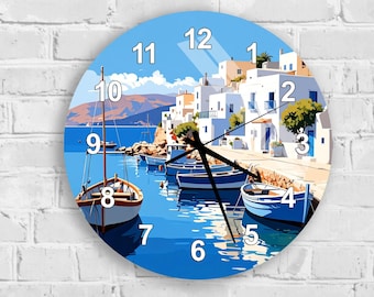 May include: Round wall clock featuring a coastal scene with boats, buildings, and water. The clock face has a blue background with white numbers and black clock hands. The clock is mounted on a white brick wall.