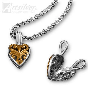 May include: A silver heart-shaped locket with a gold filigree design. The locket opens to reveal a small compartment inside. The locket is attached to a silver chain.