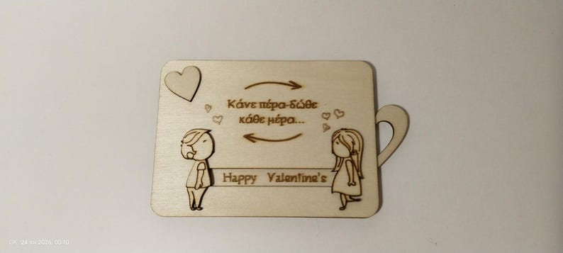 May include: A light-colored wooden plaque with a handle, featuring engraved cartoon figures of a boy and a girl facing each other. The plaque includes a heart, arrows, and the text "Happy Valentine's".
