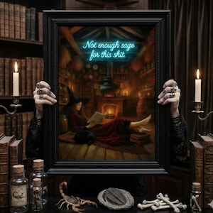 May include: A framed print depicting a witch reading in a warm room, illuminated by a fireplace and candles. The print features the neon blue text "Not enough sage for this shit". The frame is held by hands with silver rings, with jars and a scorpion nearby.
