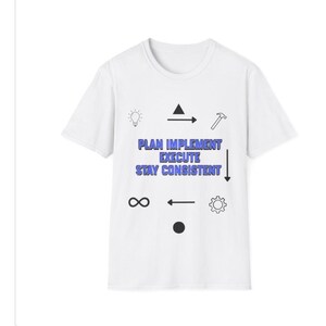 May include: A white ceramic mug with a black handle and the text "But First, Coffee" in a bold, black font. The mug is set against a blurred background, suggesting a cosy setting.