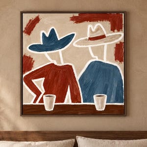 May include: A square wall art print featuring two stylised figures wearing hats, one in blue and one in beige, seated at a table with two white cups. The figures are rendered in red and blue tones against a cream background with red brushstrokes.