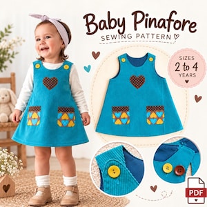 Può includere: Un vestito grembiulino per neonati in velluto a coste color ottanio con due bottoni gialli sulle spalle, un'applicazione a forma di cuore marrone sul petto e due tasche con un motivo a cuori marroni, gialli e blu. Il testo recita Baby Pinafore Sewing Pattern.