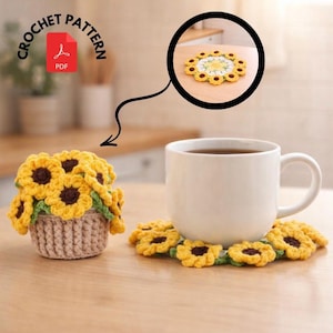 May include: A crochet pattern for a sunflower-themed set, including a coaster and a small basket of sunflowers. The coaster and sunflowers are yellow with brown centers and green leaves. The image also shows a white mug with a dark liquid.