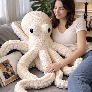 May include: A set of three ceramic mugs with a speckled, matte finish. The mugs are in shades of cream, light grey, and dark grey. Each mug has a simple, minimalist design, ideal for coffee or tea.