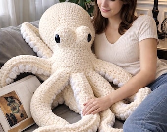 May include: A large, cream-colored crochet octopus plush toy featuring a rounded head, two prominent black plastic eyes, and eight long, flexible tentacles. The underside of each tentacle is lined with small, white, circular crocheted suction cups.