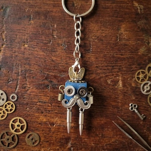 The Dapper Bolt — Handcrafted Steampunk Robot Keychain & Pendant · Screw Eyes · Bullet Legs · Vintage Brass Charm