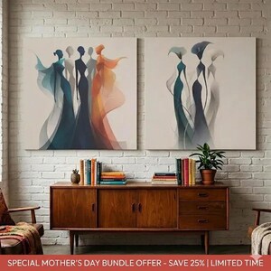 May include: Two square canvas art prints. Each features an abstract depiction of figures in flowing gowns. The colour palette includes teal, navy, orange, and white. The artwork hangs above a wooden cabinet with books and a potted plant.