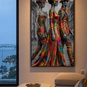 May include: A framed artwork depicts three figures in colorful patchwork clothing and hats, set against a grayscale background. The figures are walking, showcasing the vibrant patterns of their outfits. The artwork is displayed in a modern living room setting.