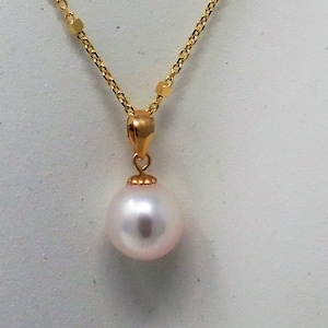 May include: A gold chain necklace with a single white pearl pendant.